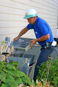 AC-technician-opening-the-outdoor-AC-unit-to-access-the-compressor