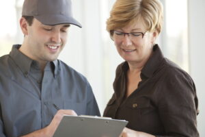 AC-technician-showing-paperwork-to-a-customer