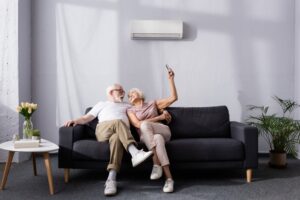 couple-relaxing-on-couch-in-front-of-mini-split-air-handler