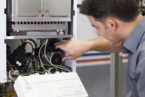 HVAC-technician-repairing-a-furnace