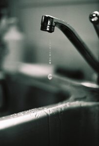 a-drop-of-water-falling-from-a-faucet