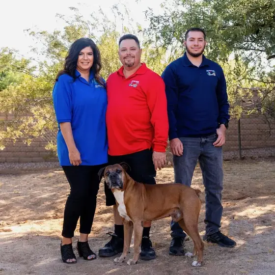 The Arenas family with their boxer dog in a Tucson backyard