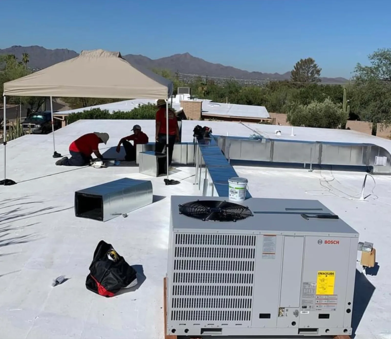 Picture Rocks technicians working on a rooftop AC unit in Tucson
