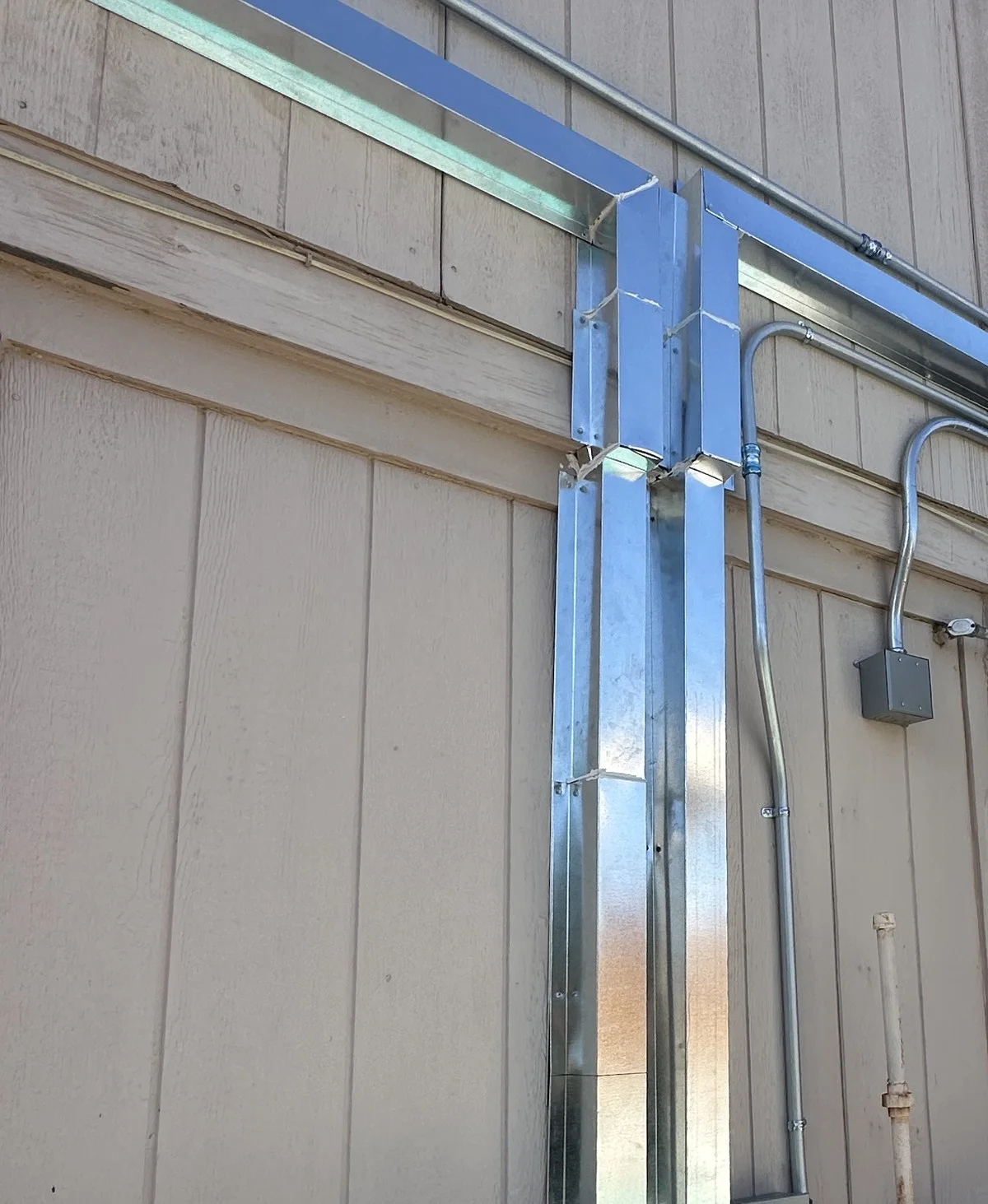 Covered line-set runs up the exterior wall.